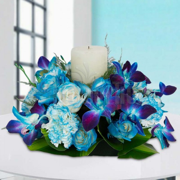 1 White Pillar Candle with 5 Blue-shaded Carnations and 5 Blue-shaded Roses and an Orchid